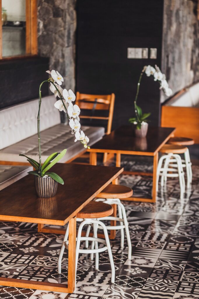 modern-wooden-furniture-in-cafe-on-floor-with-black-and-white-ornament-tile-two-chairs-table